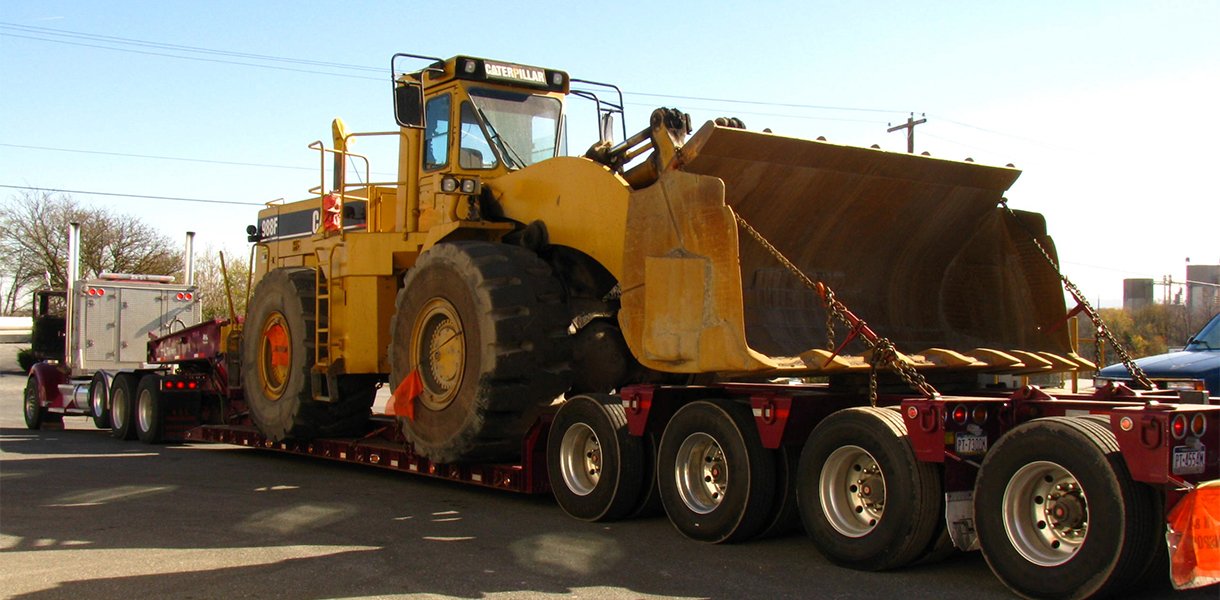 Rutt's Machine, Inc. hauling Caterpillar equipment to a customer