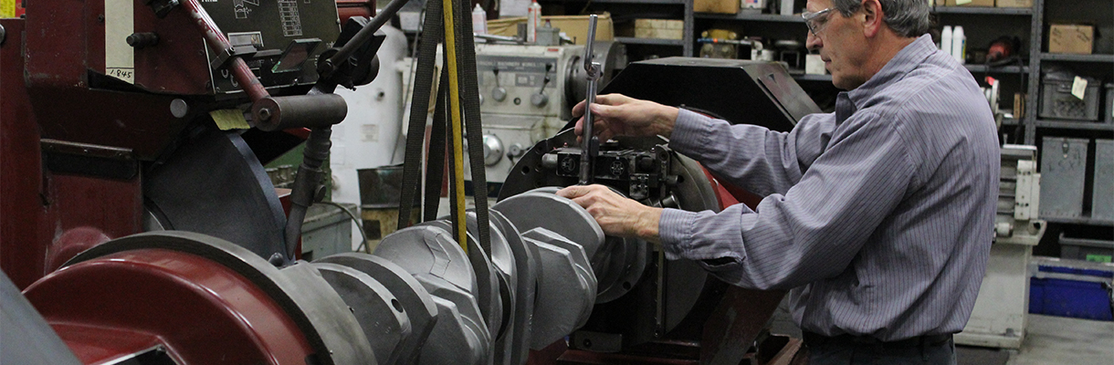 A crankshaft being rebuilt or repaired.